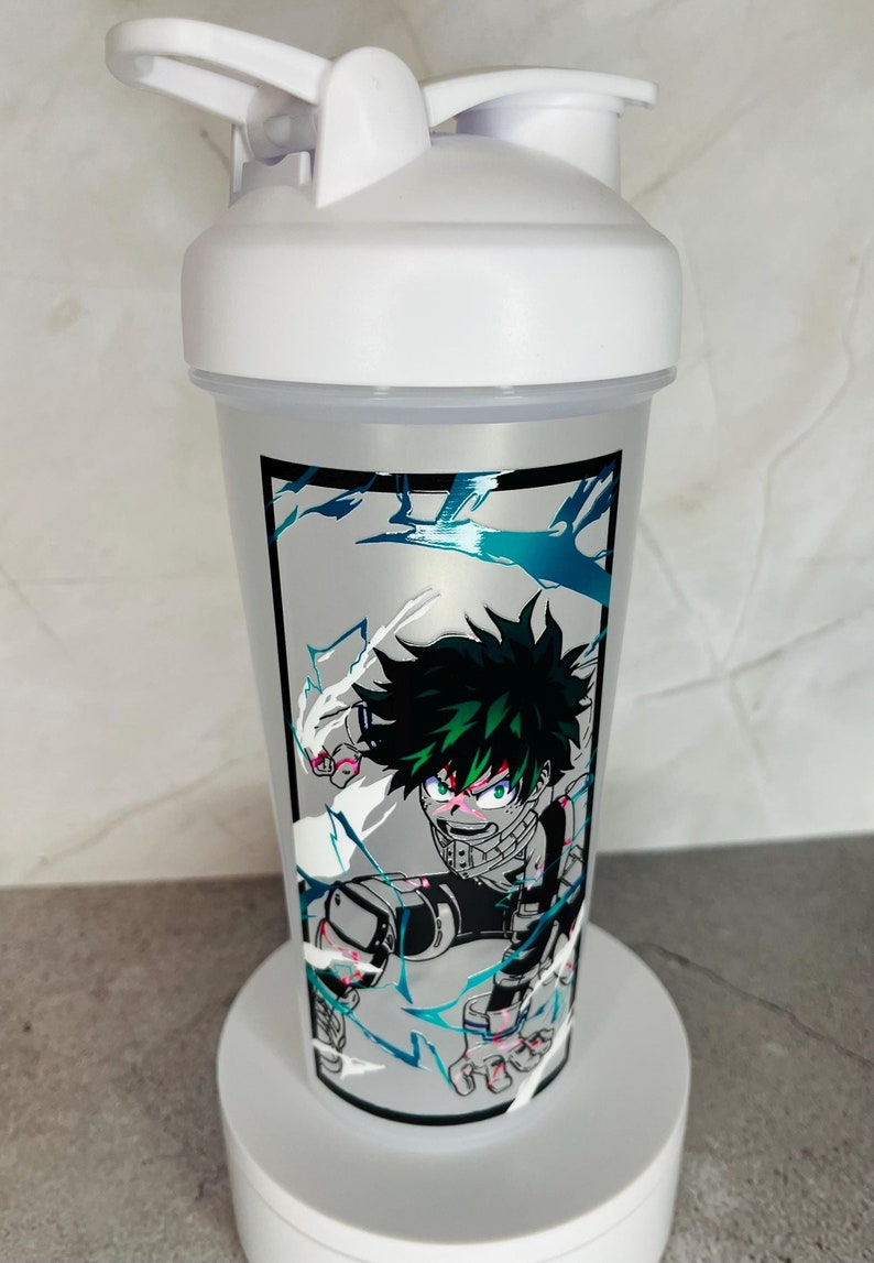 May include: White shaker bottle with a green and black anime character design. The character is a young man with green hair and a determined expression. The design includes a white background with blue and black accents.