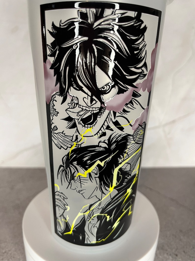 May include: A white tumbler featuring a black and white graphic of three anime characters. The characters are drawn in a manga style and have black hair and eyes. The background is a black and white pattern of lightning bolts.