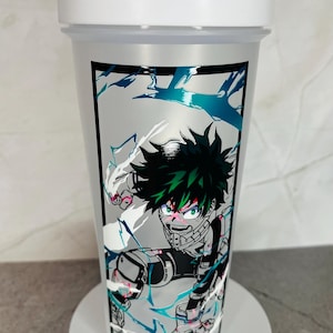 May include: White shaker bottle with a black and white graphic of a green-haired anime character with red eyes. The character is surrounded by white and blue lightning bolts.