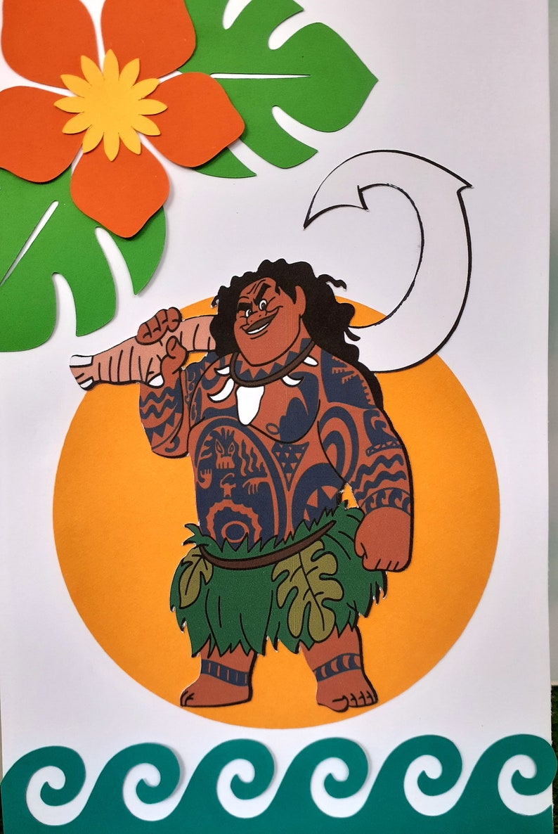 May include: A paper craft of Maui from the Disney movie Moana. Maui is holding a giant fish hook and wearing a green grass skirt and a necklace with a white bone pendant. He has brown skin, black hair, and a black tattoo on his chest. He is standing on a yellow circle with a green leaf behind him.