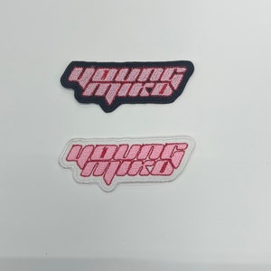 May include: Two embroidered patches with the text "Young Mxxd" in pink lettering. The top patch is black with pink lettering. The bottom patch is white with pink lettering.