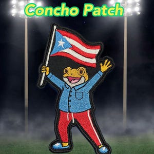 May include: Embroidered patch featuring a frog character holding a Puerto Rican flag. The frog wears a blue shirt and red pants. The patch is 3.5" wide and 6" high. Text on the patch reads "Concho Patch".