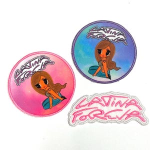 May include: Three embroidered patches with the text "Latina Forever". Two circular patches feature a cartoon illustration of a woman with brown hair and a heart on her chest. The third patch is the text "Latina Forever" in a cursive font.