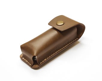 Leather belt case for multitool with metal belt clip.