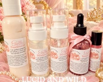 May include: A collection of four Lucid & Wild Princess Treatment skincare products, including a lotion bottle, two spray bottles with shimmer, a dropper bottle with pink contents and a ribbon, and a small roller bottle with a black cap.