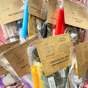 May include: A collection of spell and ritual kits in clear plastic bags, each featuring a brown paper label with a moth illustration and the brand name Lucid & Wild. The kits contain various colored candles, dried herbs, and small glass vials.