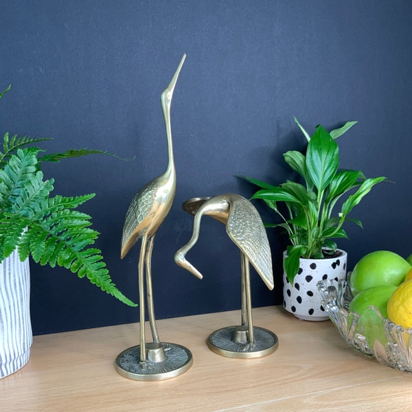 A pair of mid century brass cranes, vintage water bird ornaments, bohemian, cottage core, maximalist decor. Heron, egret, crane.