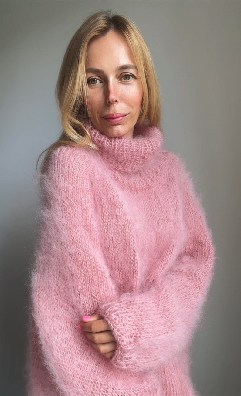 May include: A soft, pink, fuzzy turtleneck sweater.