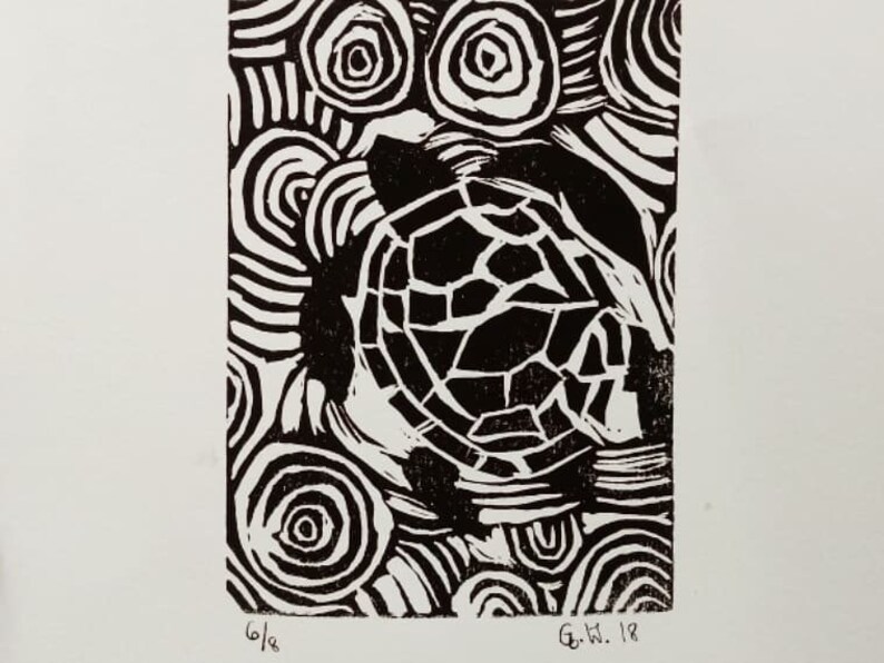 May include: Black and white linocut print of a turtle with a swirling pattern background. The print is signed "G.W. 18" in the bottom right corner.