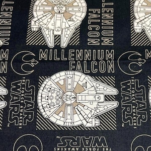 May include: Black fabric with a repeating pattern of the Millennium Falcon spaceship from Star Wars. The text "Millennium Falcon" and "Star Wars: The Force Awakens" is repeated throughout the fabric.