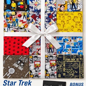May include: A 12-piece Star Trek fabric bundle featuring 10-inch cotton squares with various character and spaceship prints in black, yellow, red, and blue. A white ribbon ties the stack, and a black quilt label reads Live Long and Prosper.