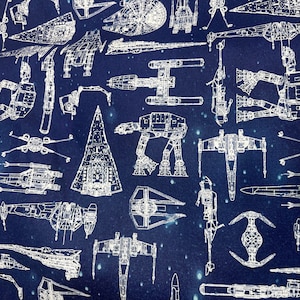 May include: A blue fabric with white outlines of various Star Wars spaceships, including X-wings, TIE fighters, and the Millennium Falcon. The fabric is perfect for crafting projects, like quilts, pillows, or tote bags.