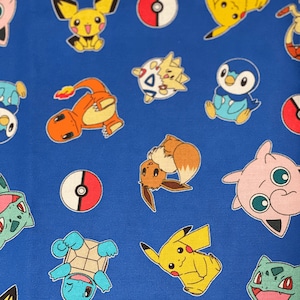 May include: Blue fabric with a repeating pattern of various Pokemon characters, including Pikachu, Charmander, Squirtle, Bulbasaur, and Eevee. The characters are in a cartoon style and are surrounded by Pokeballs.