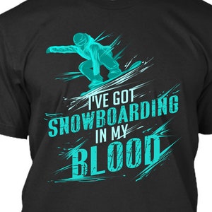 May include: Black t-shirt with a turquoise graphic of a snowboarder and the text "I'VE GOT SNOWBOARDING IN MY BLOOD." The design features a dynamic illustration of a snowboarder in action, with stylized lines suggesting motion and speed. A casual tee for snowboard enthusiasts.