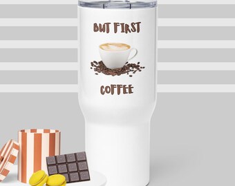 May include: White stainless steel travel mug with a brown graphic of a coffee cup and coffee beans. The text "But First Coffee" is printed on the mug.