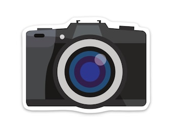 May include: A black camera with a large lens. The lens has a blue and gray ring around it.