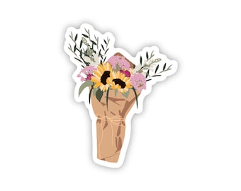 May include: A sticker featuring a bouquet of flowers wrapped in brown paper. The bouquet includes sunflowers, pink flowers, and greenery. The paper is tied with twine, and the sticker has a white border.