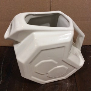 This is a fabulous Alamo Pottery White Geometric Ceramic Pitcher in excellent vintage condition.  This piece measures 7 1/2" tall, 8" wide and 5" deep and holds approximately 72 fluid ounces.