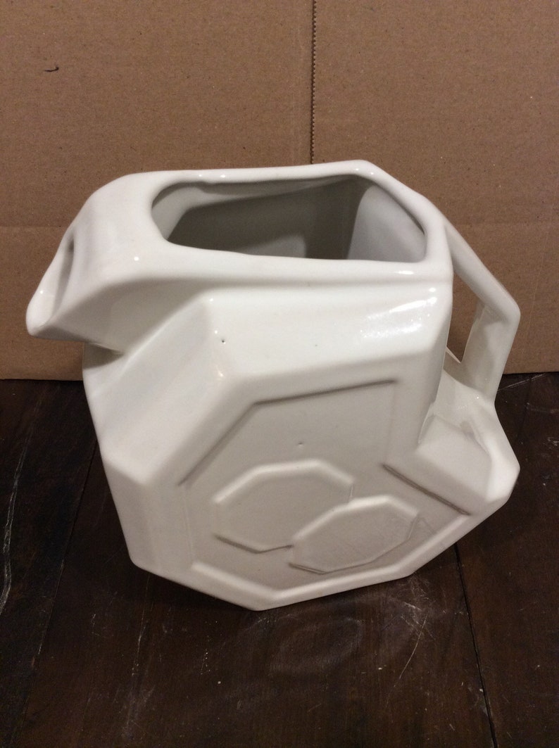 This is a fabulous Alamo Pottery White Geometric Ceramic Pitcher in excellent vintage condition.  This piece measures 7 1/2" tall, 8" wide and 5" deep and holds approximately 72 fluid ounces.