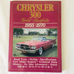 May include: A vintage book cover with the title "CHRYSLER 300 Gold Portfolio 1955-1970" in gold lettering on a maroon background. The cover features a red convertible car on a grassy field. Text includes "Road Tests", "Styling", and "Specifications".