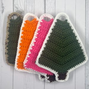 May include: Four crocheted Christmas tree dishcloths in green, orange, pink, and camouflage. Each dishcloth has a white border and a loop for hanging.