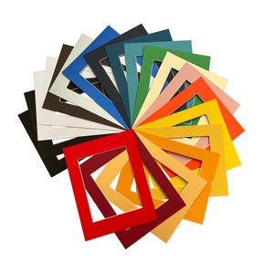 May include: A selection of coloured mount boards arranged in a circle, displaying various shades of red, orange, yellow, green, blue, and purple.