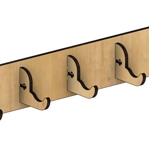May include: A wooden wall-mounted coat rack with five hooks. The rack is made of light brown wood and has a natural finish. The hooks are made of dark brown wood and are shaped like a simple curve.
