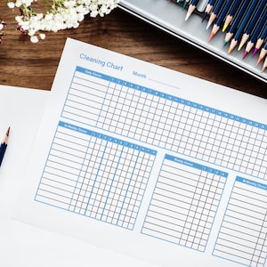 May include: A printable cleaning chart with sections for daily, bi-weekly, weekly, and bi-monthly chores. The chart is divided into a grid with numbered days of the month.