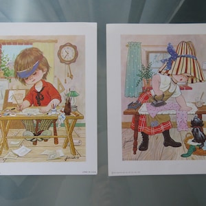 May include: Two vintage illustrations of children. The first shows a girl with a blue headband drawing at a table with a cat nearby. The second shows a girl with a striped hat ironing a piece of clothing.