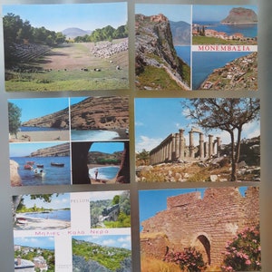 May include: A collection of vintage postcards featuring scenic views. The postcards depict landscapes with mountains, beaches, and historical sites. One postcard has the word "MONEMBASIA" and another has the words "Μηλιές - Καλά Νερά".