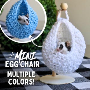 May include: Two crocheted mini egg chairs, one blue and one white, with a small rodent sitting inside each. The text "Mini Egg Chair Multiple Colors!" is displayed below the chairs.