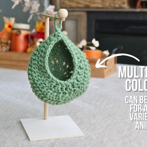 May include: Green crocheted hanging pet bed on a white stand. Get multiple colors! Can be used for a wide variety of animals!