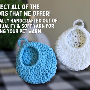 May include: Two crocheted pet beds, one blue and one white.  The beds are handmade and made with soft yarn.  "COLLECT ALL OF THE COLORS THAT WE OFFER! ETHICALLY HANDCRAFTED OUT OF HIGH QUALITY & SOFT YARN FOR KEEPING YOUR PET WARM" is written in white text on a black background.