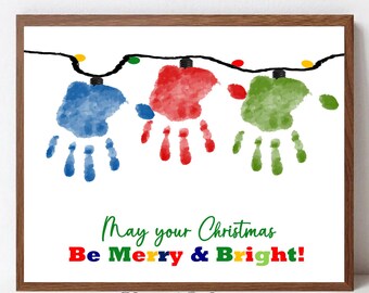 May include: A Christmas-themed printable featuring a string of lights made from handprints in blue, red, and green. The text reads "May your Christmas Be Merry & Bright!"