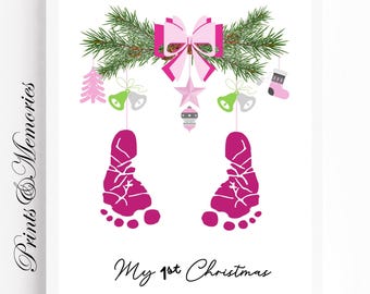May include: Pink baby footprints with a Christmas theme. The footprints are surrounded by a green garland with a pink bow, bells, a star, and a stocking. The text "My 1st Christmas" is written below the footprints.