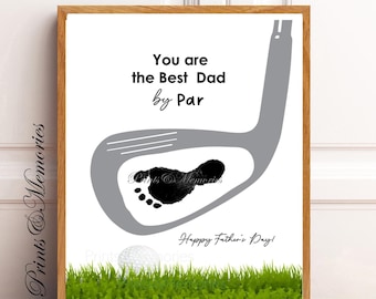 May include: Framed print with a golf theme. The artwork features a gray golf club design with a black footprint inside. Text reads "You are the Best Dad by Par" and "Happy Father's Day!" A golf ball rests on green grass.