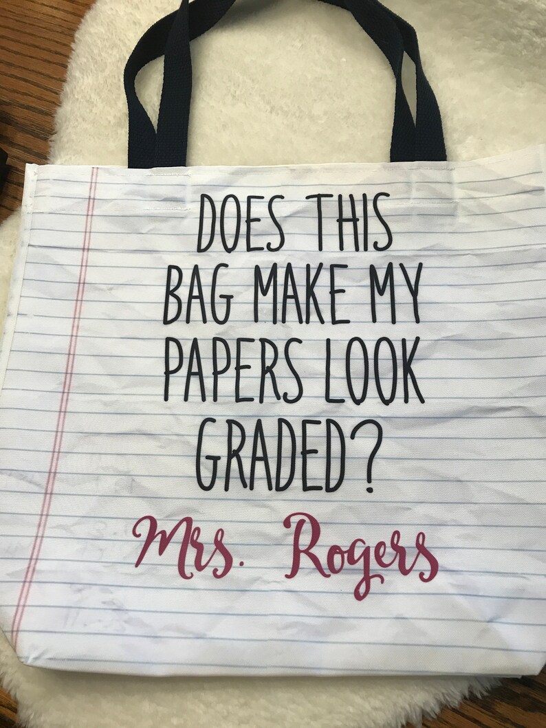 May include: White canvas tote bag with black text that reads "Does this bag make my papers look graded?" and "Mrs. Rogers" in pink text.
