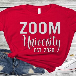 May include: Red t-shirt with the text "ZOOM University EST. 2020" in white.