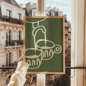 May include: A framed green canvas print with a white illustration of two cups and a faucet pouring water into one of the cups.