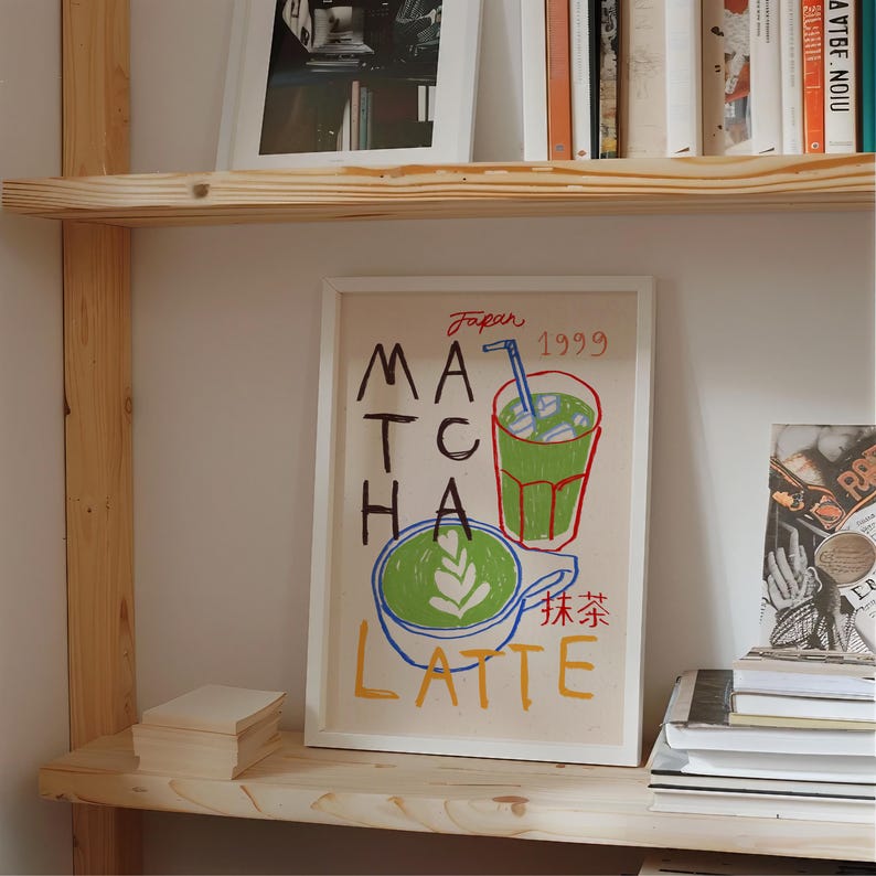 Peut inclure: Une impression encadr&eacute;e blanche avec une illustration color&eacute;e d'un verre de latte au matcha et le texte "Japan 1999 Matcha Latte" en rouge, bleu et vert. Le texte "抹茶ラテ" est &eacute;crit en japonais.
