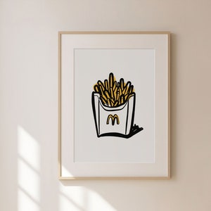 K&ouml;nnte beinhalten: Ein gerahmter Druck einer Schwarzwei&szlig;illustration einer Schachtel Pommes mit einem gelben 'M'-Logo. Die Pommes sind gelb und die Schachtel ist wei&szlig;.