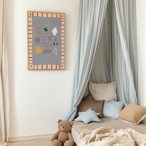 May include: A light blue canopy bed with a brown teddy bear sitting on the bed. The wall behind the bed has a framed print with a gray background and colorful illustrations of a sun, moon, rainbow, stars, and a bird. The print has the text "Lucky to have you".