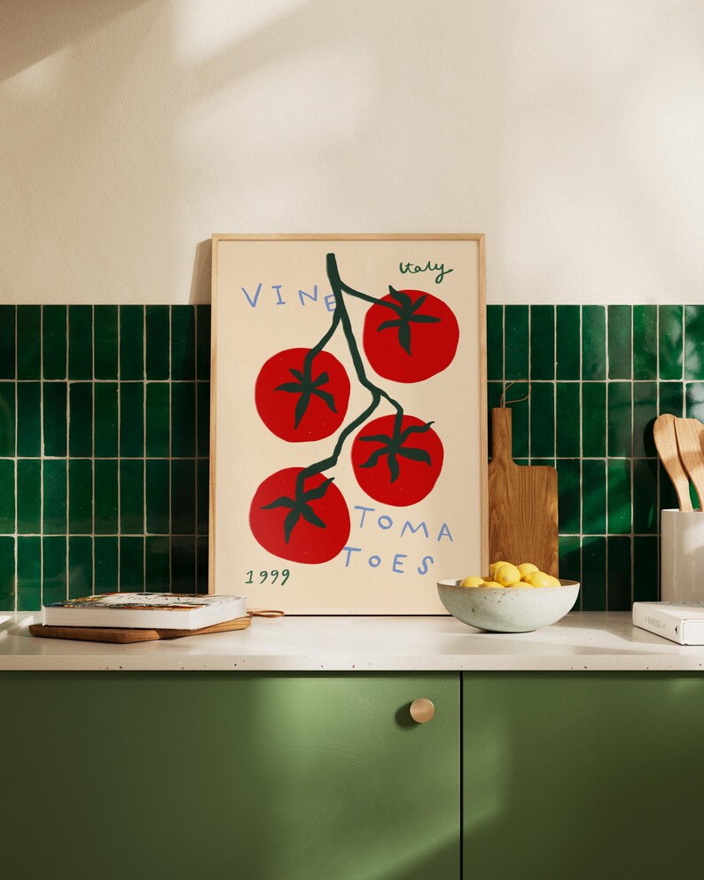 May include: A framed print with a white background and a stylised illustration of a vine with red tomatoes. The text "Vine Tomatoes" is written in black and the text "Italy 1999" is written in black at the bottom of the print.