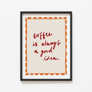 May include: Framed print with a white background and orange and white checkered border. The text "Coffee is always a good idea." is written in red cursive.