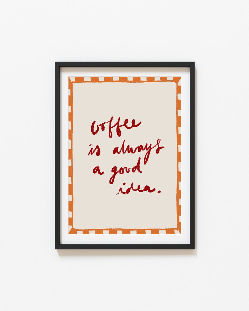 May include: Framed print with a white background and orange and white checkered border. The text "Coffee is always a good idea." is written in red cursive.