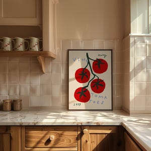 May include: A framed print of a red tomato vine with the text "Italy Vine Tomatoes 1999" in a kitchen setting.