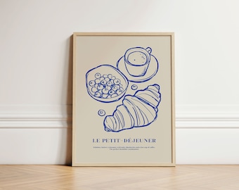 May include: A blue and white illustration of a croissant, blueberries, and a cup of coffee. The text "LE PETIT - DÉJEUNER" is below the illustration. The text reads "Delicious, buttery croissants with juicy blueberries and a hot cup of coffee. The perfect breakfast combination."