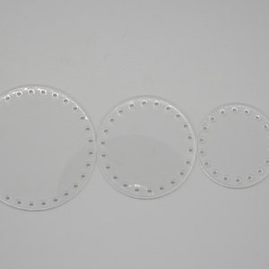 May include: Three clear, circular acrylic bases for crafting projects. Each base has a series of evenly spaced holes around the perimeter. The sizes vary, with the largest measuring approximately 8 inches in diameter, and the smallest about 4 inches.