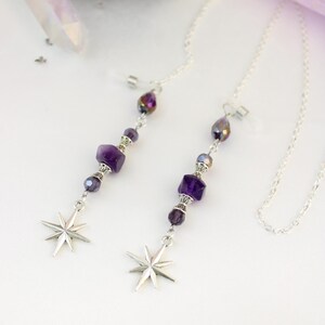 May include: Two silver eyeglass chains with purple amethyst beads and starburst charms. The chains have a delicate design with faceted beads and a teardrop-shaped bead at the top. The starburst charms are silver and have eight points.