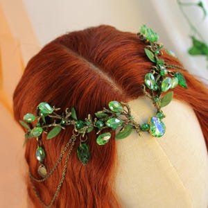 Bronze tiara with shimmering gree. Teardrop and round crystal beads, bronze dangling chains and deep green leaf shaped beads